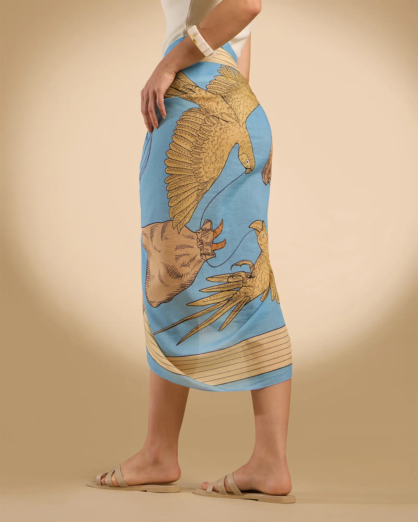 Woman model wearing Illustrated light blue rectangle scarf as a pareo/sarong
