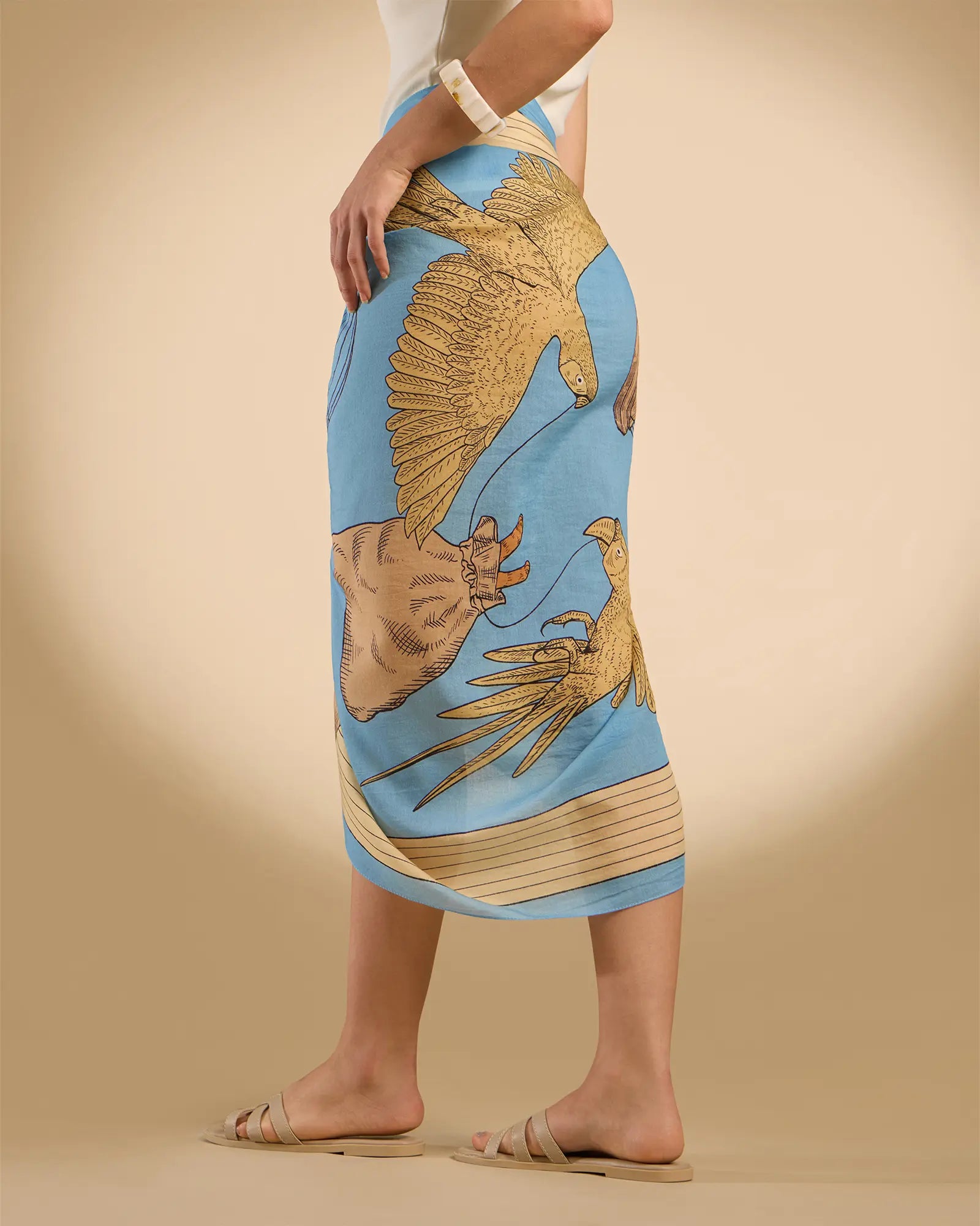 Woman model wearing Illustrated light blue rectangle scarf as a pareo/sarong