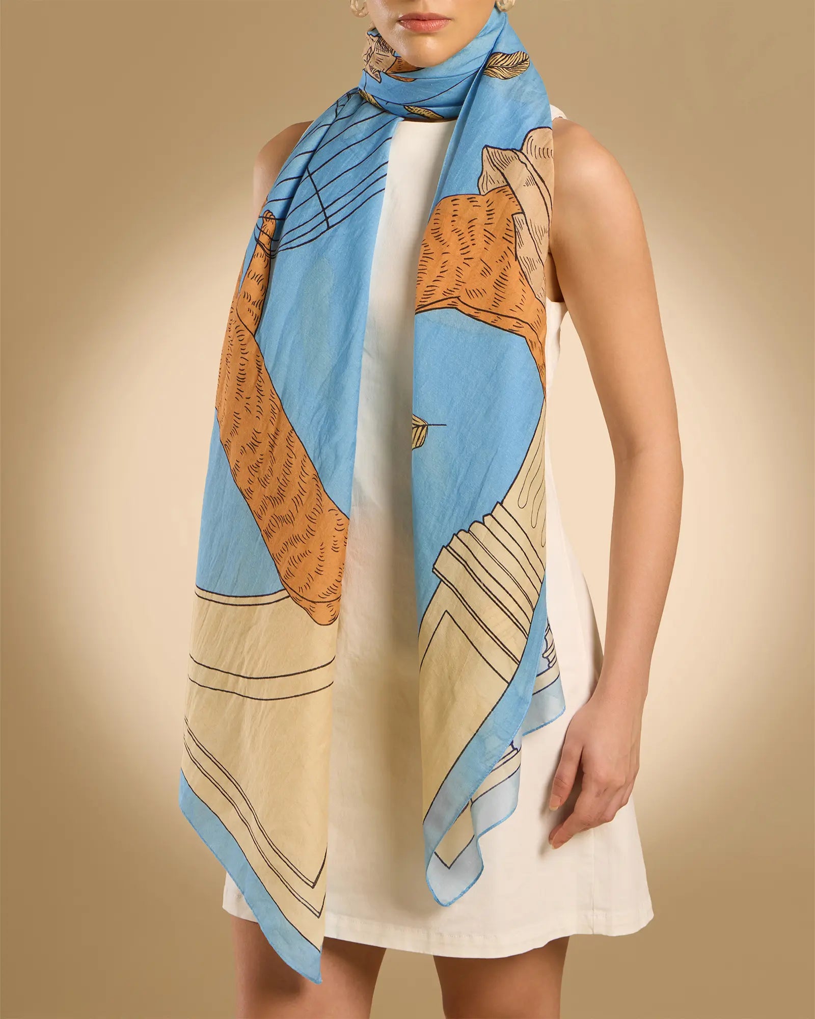 Woman model wearing Illustrated light blue rectangle scarf with classical design featuring a cat, parrots and pillars 